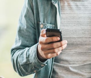 Close up of hand holding a mobile phone